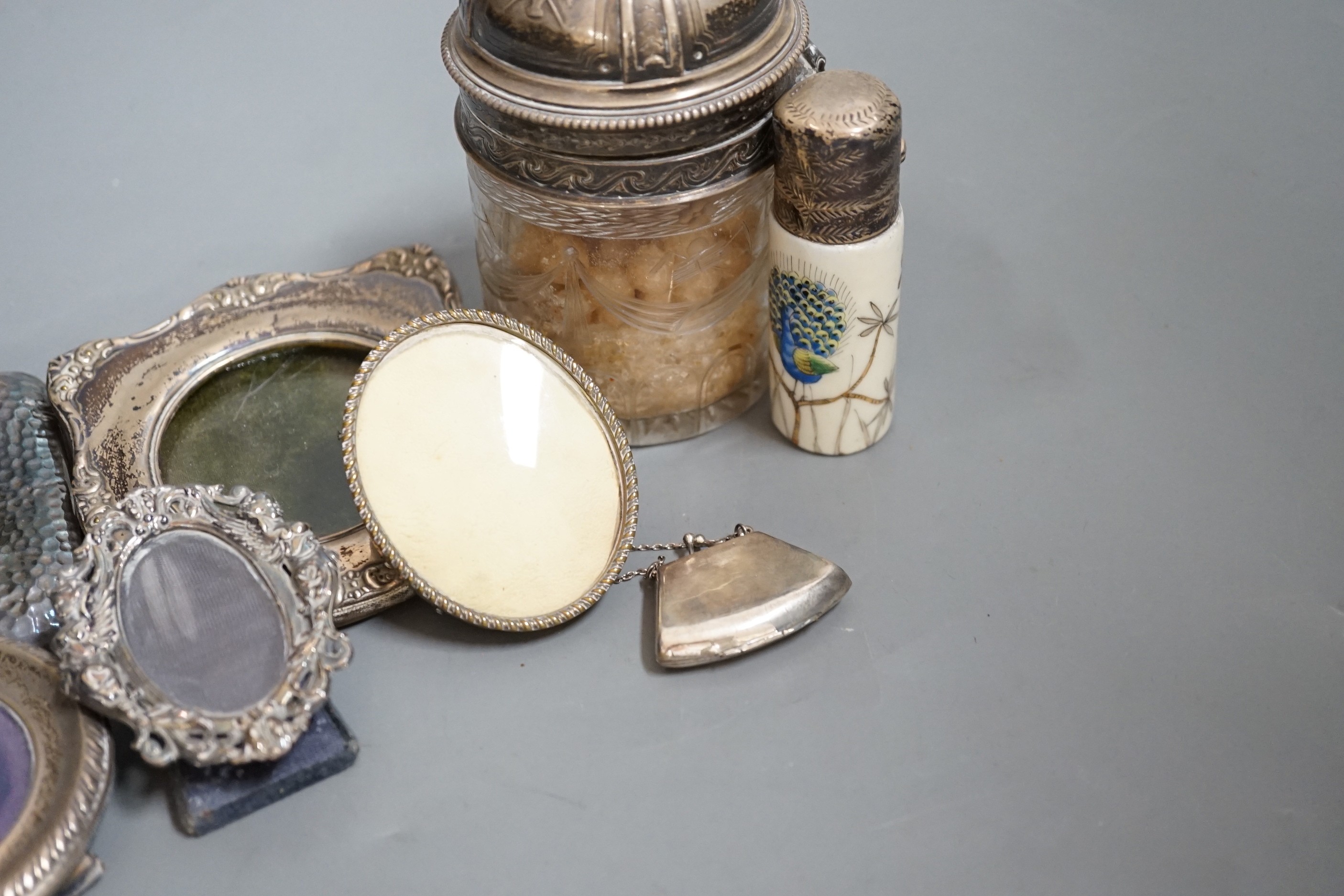 Four small silver mounted photograph frames, one brass frame, a silver lidded jar and one other and a 925 handbag pill box.